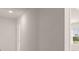 Hallway featuring neutral colored walls and view of a window overlooking the outdoors at 5430 Flat Rock Pt, Stonecrest, GA 30038