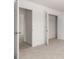 Hallway leading to walk-in closet, featuring white walls and neutral carpet at 5430 Flat Rock Pt, Stonecrest, GA 30038