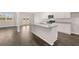 Modern kitchen featuring stainless appliances, center island and sleek wood-look flooring at 5430 Flat Rock Pt, Stonecrest, GA 30038
