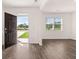 Inviting living room featuring wood-look floors and a view to the outdoors through the open front door at 5430 Flat Rock Pt, Stonecrest, GA 30038