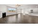 Open-concept living space with fireplace, wood-look floors, and windows with natural light at 5430 Flat Rock Pt, Stonecrest, GA 30038