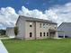 Exterior of new two-story home features a well-manicured lawn and covered porch at 1107 Kingston Hill Dr, Loganville, GA 30052