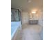 Stylish bathroom features marble-look tile, a glass shower enclosure, and a modern double vanity at 1107 Kingston Hill Dr, Loganville, GA 30052