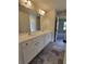 Bright bathroom featuring a double sink vanity with white cabinets and modern fixtures at 1107 Kingston Hill Dr, Loganville, GA 30052