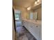 Bright bathroom featuring a double sink vanity with white cabinets and modern fixtures at 1107 Kingston Hill Dr, Loganville, GA 30052
