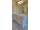 Bathroom featuring a large vanity with marble countertop and a large mirror at 1107 Kingston Hill Dr, Loganville, GA 30052
