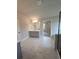 Bathroom featuring marble flooring, a double vanity, and a glass shower, with a door that leads to a walk-in closet at 1107 Kingston Hill Dr, Loganville, GA 30052