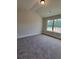 Large bedroom featuring big windows and carpet floors at 1107 Kingston Hill Dr, Loganville, GA 30052