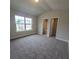 Bedroom featuring neutral carpet and views outside at 1107 Kingston Hill Dr, Loganville, GA 30052