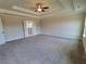 Spacious bedroom featuring a tray ceiling with a ceiling fan and plush carpeting at 1107 Kingston Hill Dr, Loganville, GA 30052