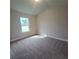 Bedroom featuring neutral carpet and a window at 1107 Kingston Hill Dr, Loganville, GA 30052