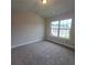 Bedroom featuring neutral carpet and a window at 1107 Kingston Hill Dr, Loganville, GA 30052