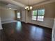Elegant dining room with hardwood floors, wainscoting, and a chandelier at 1107 Kingston Hill Dr, Loganville, GA 30052