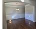 Charming dining room with hardwood floors, wainscoting, and a classic chandelier at 1107 Kingston Hill Dr, Loganville, GA 30052