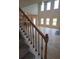 View of the foyer with a staircase featuring wood and iron railings, and light hardwood flooring at 1107 Kingston Hill Dr, Loganville, GA 30052