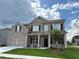 Charming two-story brick home featuring a two-car garage and a welcoming covered front porch at 1107 Kingston Hill Dr, Loganville, GA 30052