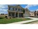 Charming two-story home with brick facade, landscaped yard, and a two-car garage at 1107 Kingston Hill Dr, Loganville, GA 30052
