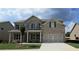 Beautiful two-story home with a brick and siding exterior, a well-manicured lawn, and two-car garage at 1107 Kingston Hill Dr, Loganville, GA 30052