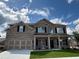 Beautiful two-story home featuring a brick facade, a two-car garage and covered front porch entrance at 1107 Kingston Hill Dr, Loganville, GA 30052