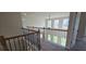 Hallway with wood railing overlooking downstairs at 1107 Kingston Hill Dr, Loganville, GA 30052