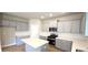 Modern kitchen featuring gray cabinets, quartz countertops, an island, and stainless steel appliances at 1107 Kingston Hill Dr, Loganville, GA 30052