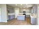 Modern kitchen with gray cabinets, quartz countertops, stainless steel appliances, and an island at 1107 Kingston Hill Dr, Loganville, GA 30052