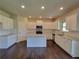 Well-appointed kitchen with white cabinets, granite countertops, and stainless steel appliances at 1107 Kingston Hill Dr, Loganville, GA 30052