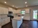 Modern kitchen featuring white cabinets, granite countertops, and stainless steel appliances at 1107 Kingston Hill Dr, Loganville, GA 30052