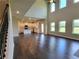 Open-concept living room boasts tall ceilings, hardwood floors, and seamless flow to the kitchen at 1107 Kingston Hill Dr, Loganville, GA 30052