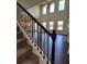 Inviting living room featuring soaring ceilings, hardwood floors, and large windows for natural light at 1107 Kingston Hill Dr, Loganville, GA 30052