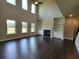 Bright living room with a fireplace, custom built-ins, hardwood floors and large windows at 1107 Kingston Hill Dr, Loganville, GA 30052