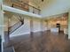 Open concept living room with a loft, hardwood floors, modern lighting and fireplace at 1107 Kingston Hill Dr, Loganville, GA 30052