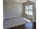 Spacious living room with plush carpeting and large windows at 1107 Kingston Hill Dr, Loganville, GA 30052