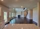 Open-concept living room featuring high ceilings, hardwood floors, fireplace, and built-in shelving at 1107 Kingston Hill Dr, Loganville, GA 30052