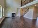Spacious living room with fireplace, built-in bookcases, hardwood floors, and natural lighting at 1107 Kingston Hill Dr, Loganville, GA 30052