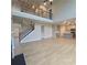 Open floor plan with hardwood floors, stairs and a gray kitchen with an island at 1107 Kingston Hill Dr, Loganville, GA 30052