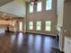 Spacious living room featuring soaring ceilings, hardwood floors, and a cozy fireplace at 1107 Kingston Hill Dr, Loganville, GA 30052
