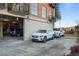 Secured parking area featuring multiple parked cars in front of a brick building with balcony at 560 Dutch Vly # 2313, Atlanta, GA 30324