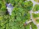 Picturesque aerial view highlighting the property's location with its proximity to a pond and treed surroundings at 6520 Glen Pond Trce, Cumming, GA 30028