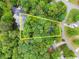 Picturesque aerial view highlighting the property's location with its proximity to a pond and treed surroundings at 6520 Glen Pond Trce, Cumming, GA 30028