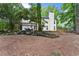 Charming backyard with a pergola-covered patio, complemented by landscaped garden beds and mature trees at 6520 Glen Pond Trce, Cumming, GA 30028