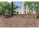 Spacious backyard featuring a pergola, landscaped garden beds, and mature trees providing a private outdoor area at 6520 Glen Pond Trce, Cumming, GA 30028