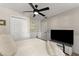 Bright bedroom featuring a ceiling fan, closet, and TV for your relaxation and convenience at 6520 Glen Pond Trce, Cumming, GA 30028