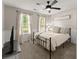 Cozy bedroom featuring a ceiling fan, and two windows allowing natural light to illuminate the space at 6520 Glen Pond Trce, Cumming, GA 30028