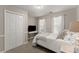 Bright bedroom featuring a closet, a TV, and natural light streaming through the windows at 6520 Glen Pond Trce, Cumming, GA 30028