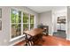 Cozy dining area with large windows, adjacent to laundry room, and bright natural lighting at 6520 Glen Pond Trce, Cumming, GA 30028
