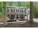 Charming two-story home featuring a beautifully landscaped yard and inviting front porch with rocking chairs at 6520 Glen Pond Trce, Cumming, GA 30028