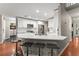 Modern kitchen with white cabinets, stone countertops, stainless appliances, and breakfast bar at 6520 Glen Pond Trce, Cumming, GA 30028