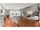 Open-concept living space featuring a modern kitchen, living room, and dining area at 6520 Glen Pond Trce, Cumming, GA 30028