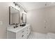 Modern bathroom featuring marble countertops, double sinks, black hardware, and subway tile at 6520 Glen Pond Trce, Cumming, GA 30028